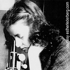 photo of Esther Lederberg looking through a microscope