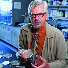 photo of Marcin Filutowicz holding a petri dish